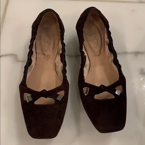 Brown suede Tod’s flats.